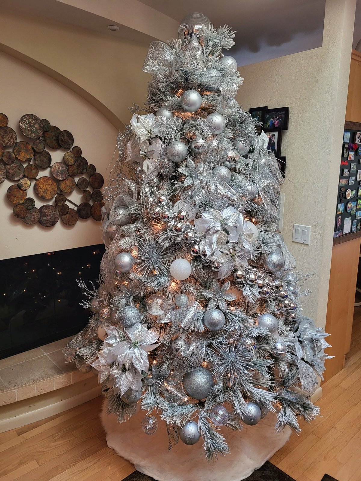 Silver and white Christmas tree with layered ornaments and silver picks