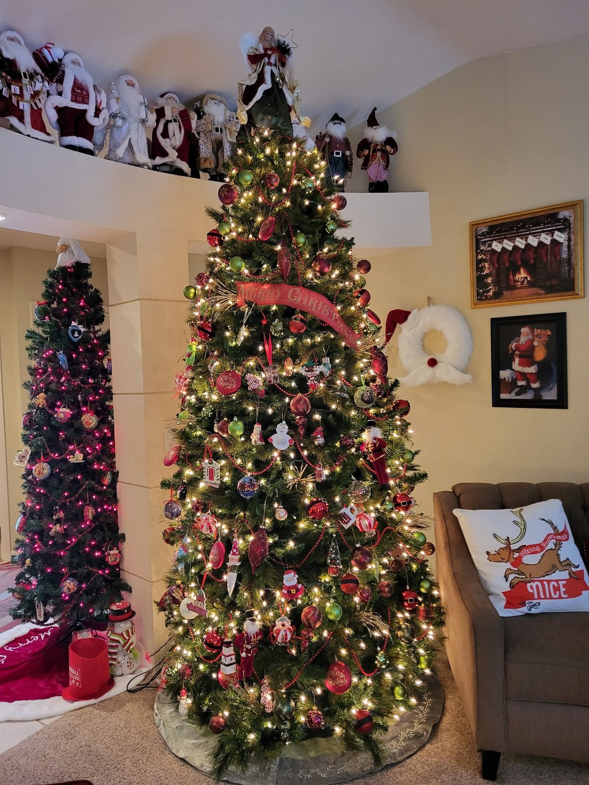 Christmas tree beside a wall of framed art and a holiday wreath