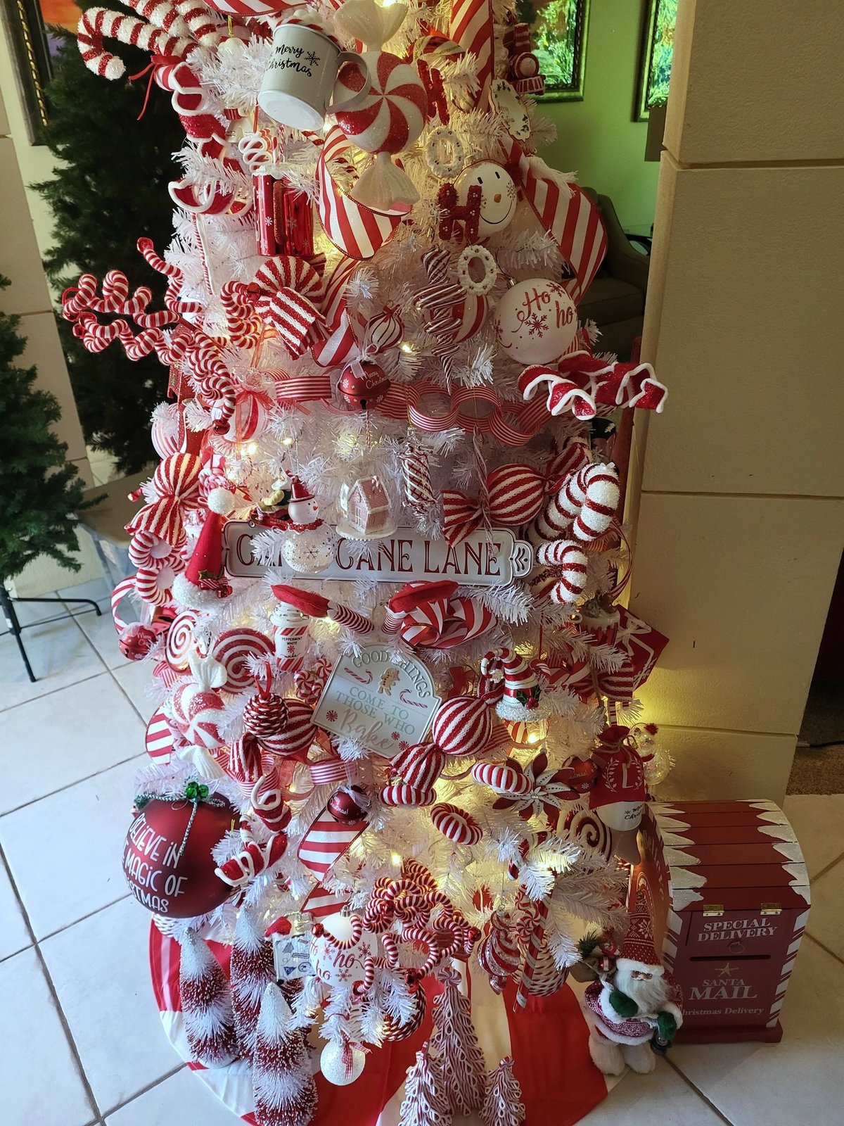 Red and white candy cane tree with layered ribbon and candy ornaments