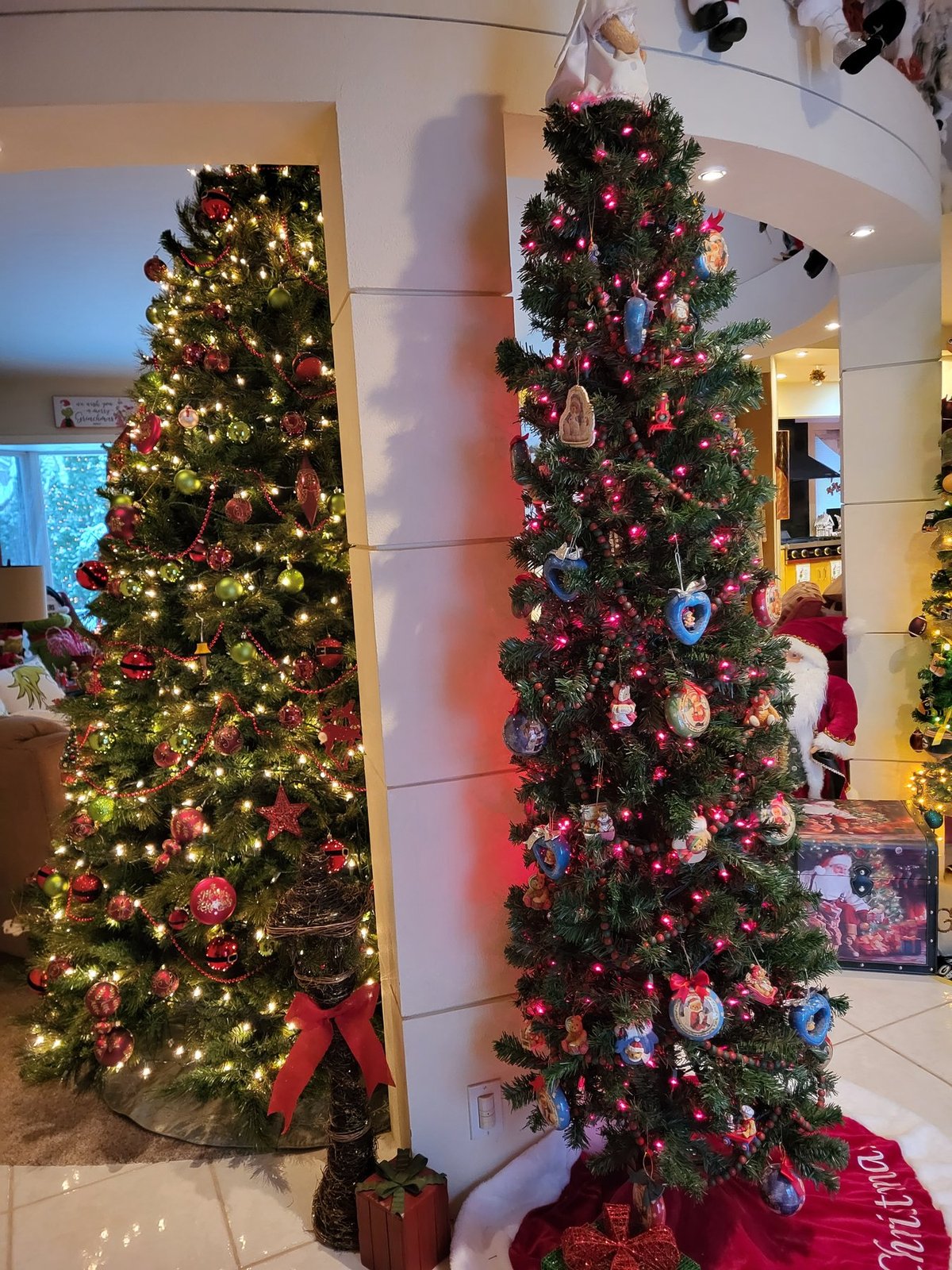 A pair of decorated Christmas trees flanking a doorway