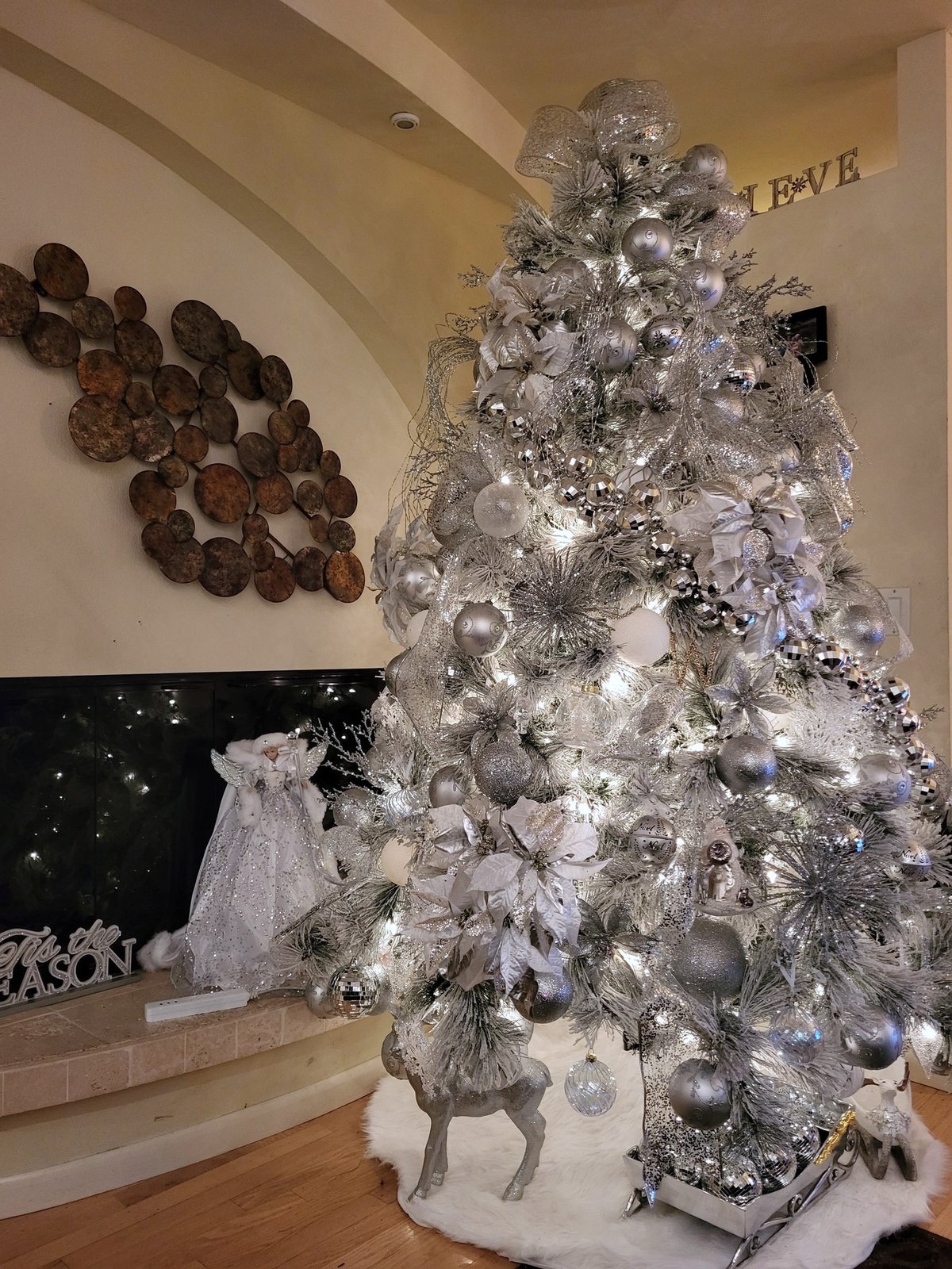 White and silver Christmas tree with oversized ornaments and starburst picks