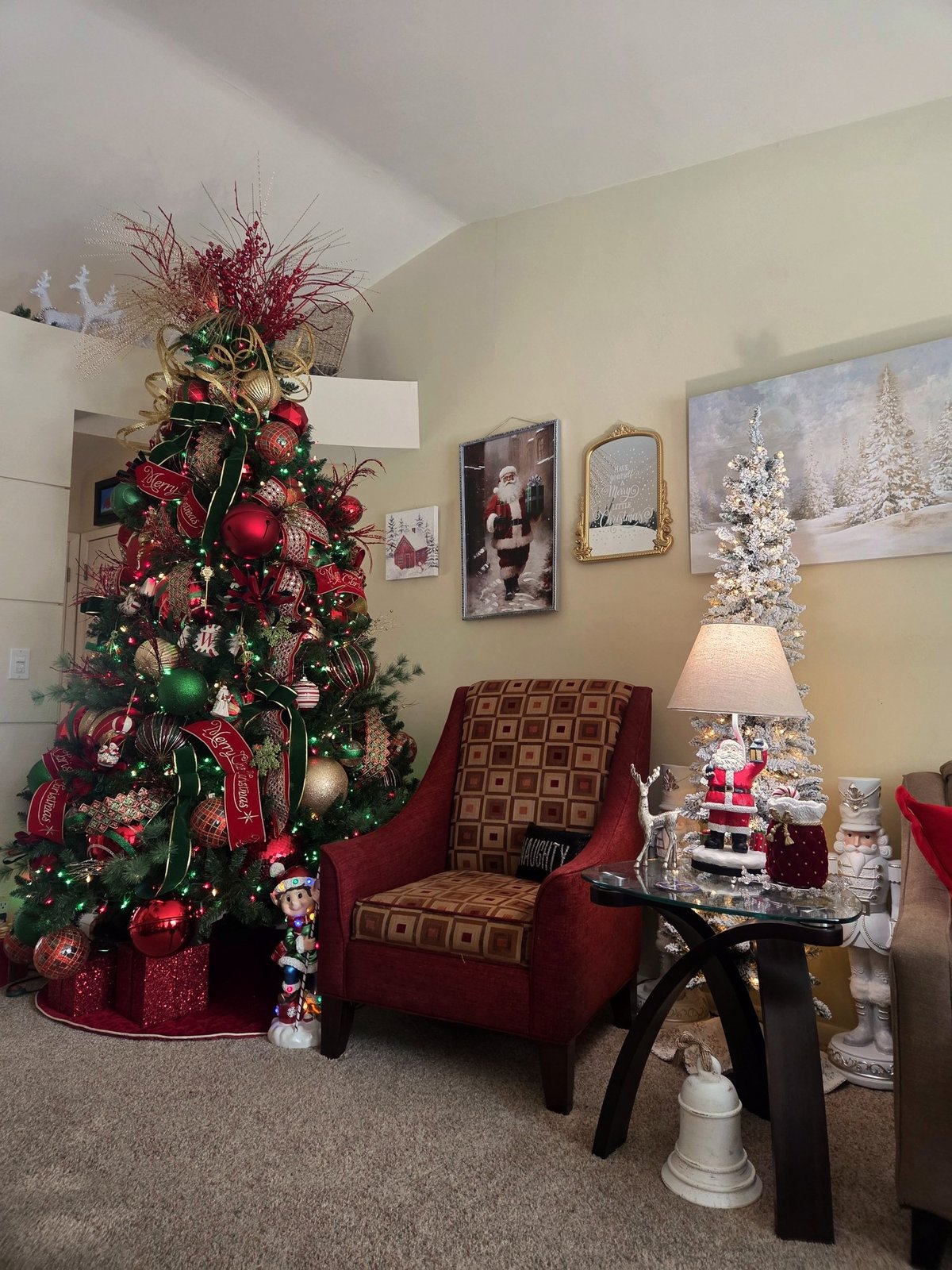 Decorated Christmas trees and a lamp in a warmly lit sitting room
